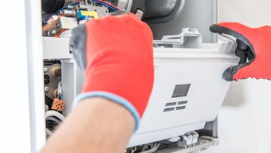Gloved technician opening furnace.