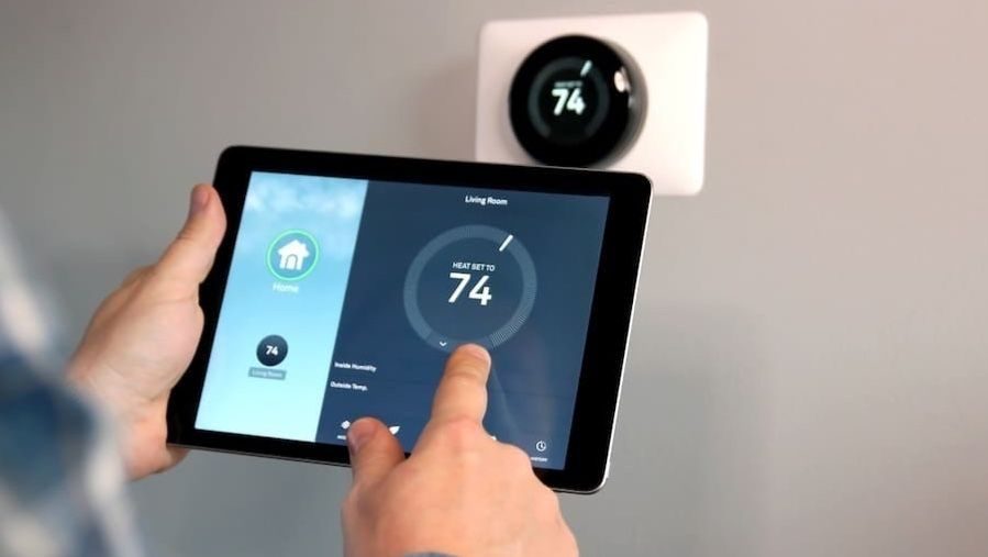 Smart thermostat being turned on by iPad.