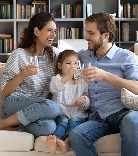 Family sitting together in New Jersey is drinking clean water | New Jersey Plumbing Services | Call Harris Now