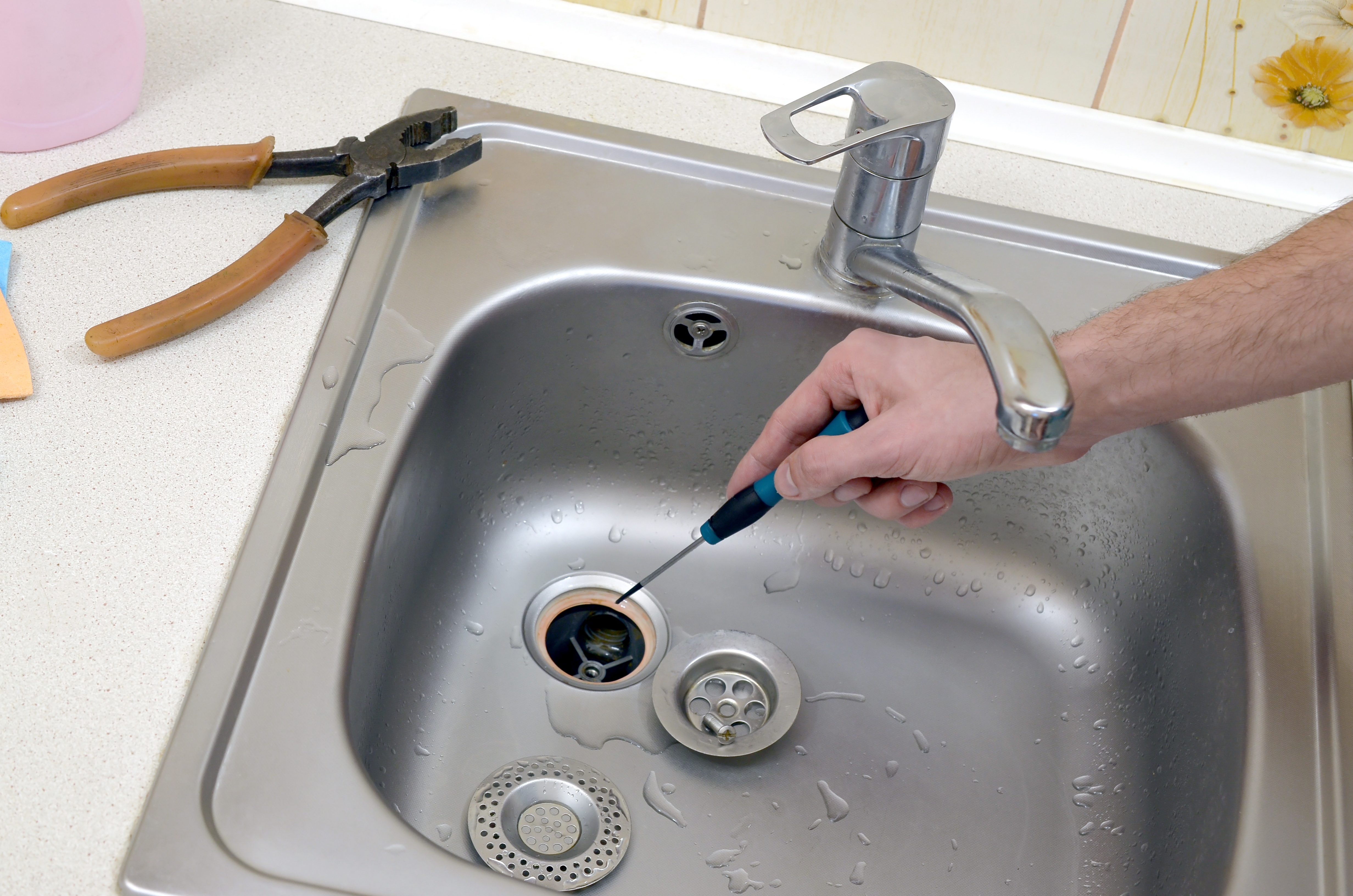 A plumber in New Jersey fixing the sink drain | New Jersey Drain Services | Call Harris Now