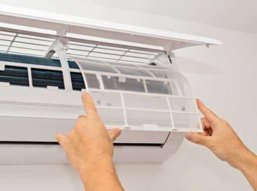 A repair man in New Jersey changing the AC Filter | New Jersey Cooling Services | Call Harris Now