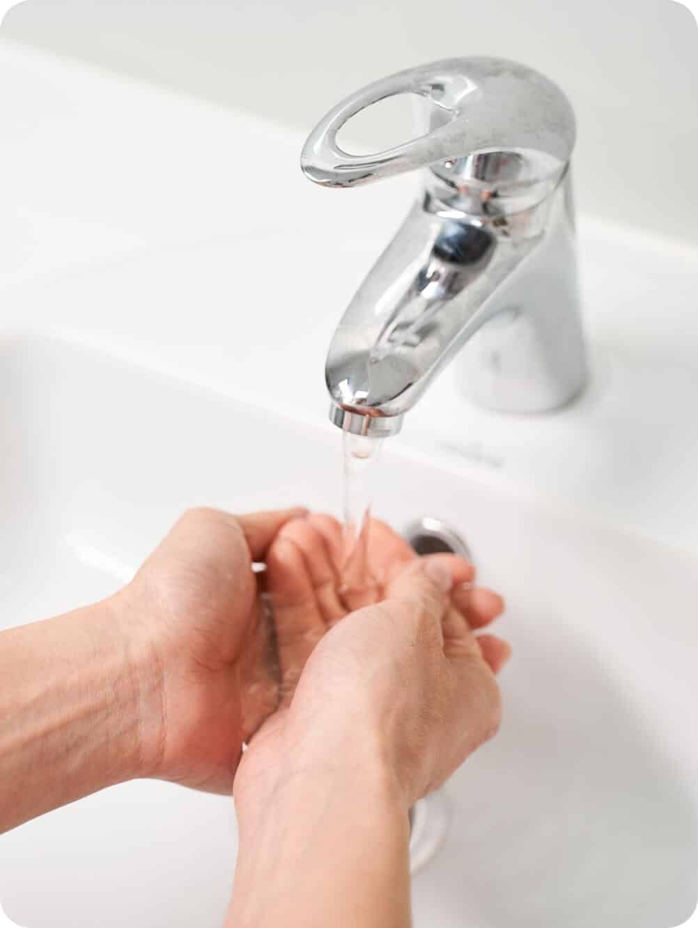 Plumber in Delaware checking water flow after installing faucet | Delaware Plumbing Services | Call Harris Now
