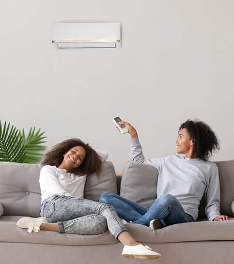Mother and daughter in New Jersey sitting with Air Condition | New Jersey Cooling Services | Call Harris Now