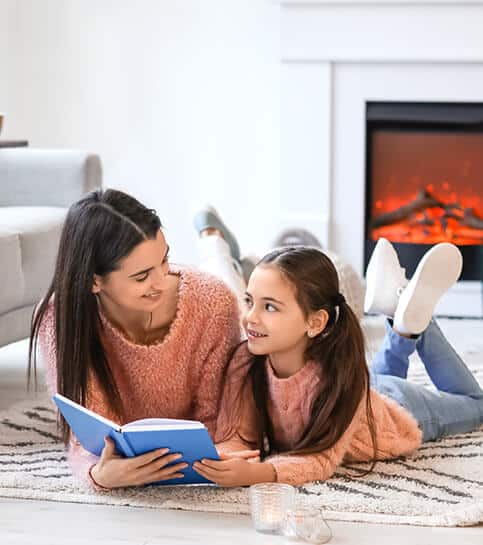 Mother and daughter in Delaware lying on a warm living room | Delaware Heating Services | Call Harris Now