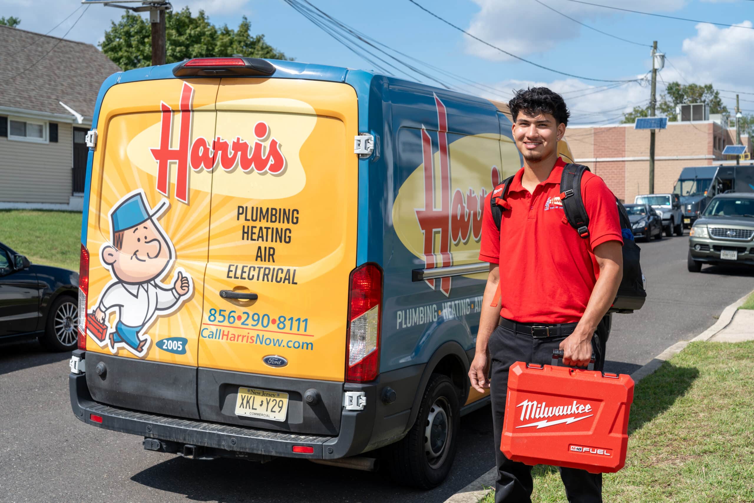 Harris technician standing in front of the Harris truck