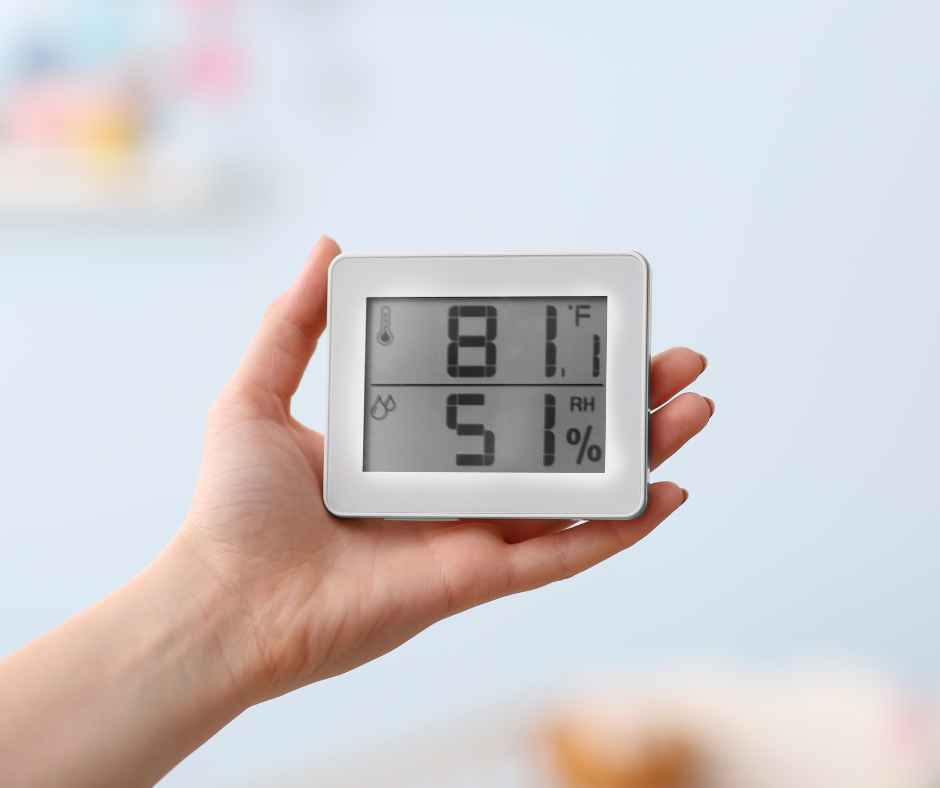 Holding a device checking temperature and humidity