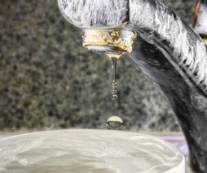 Signs of hard water buildup on a faucet