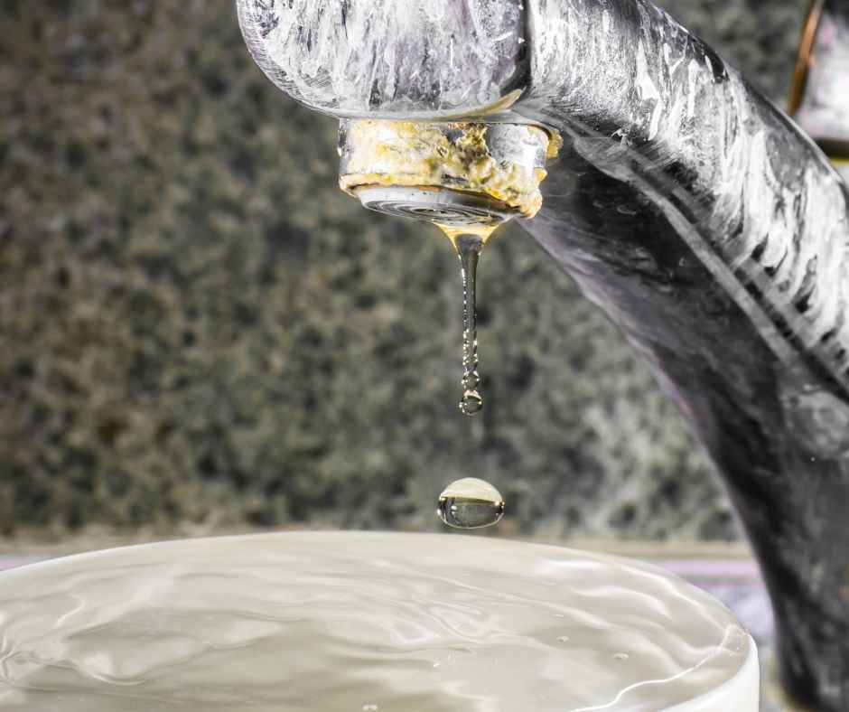 Signs of hard water buildup on a faucet