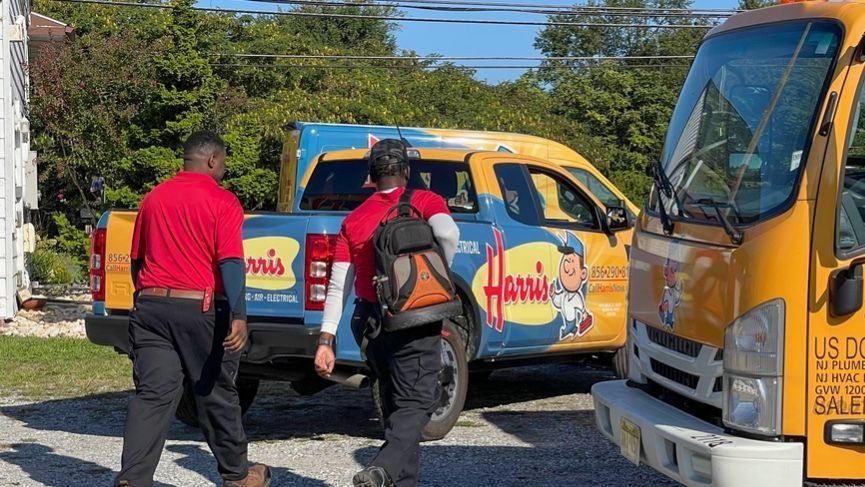 Harris technicians walking back to their van after humidifier and dehumidifier service.