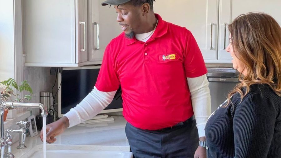Harris plumber testing kitchen plumbing.