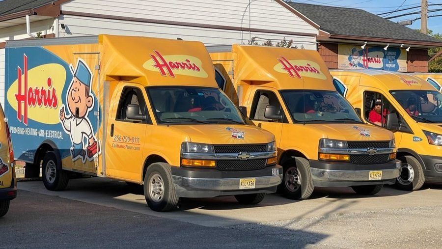 Harris vans lined up in front of brick-and-mortar location.